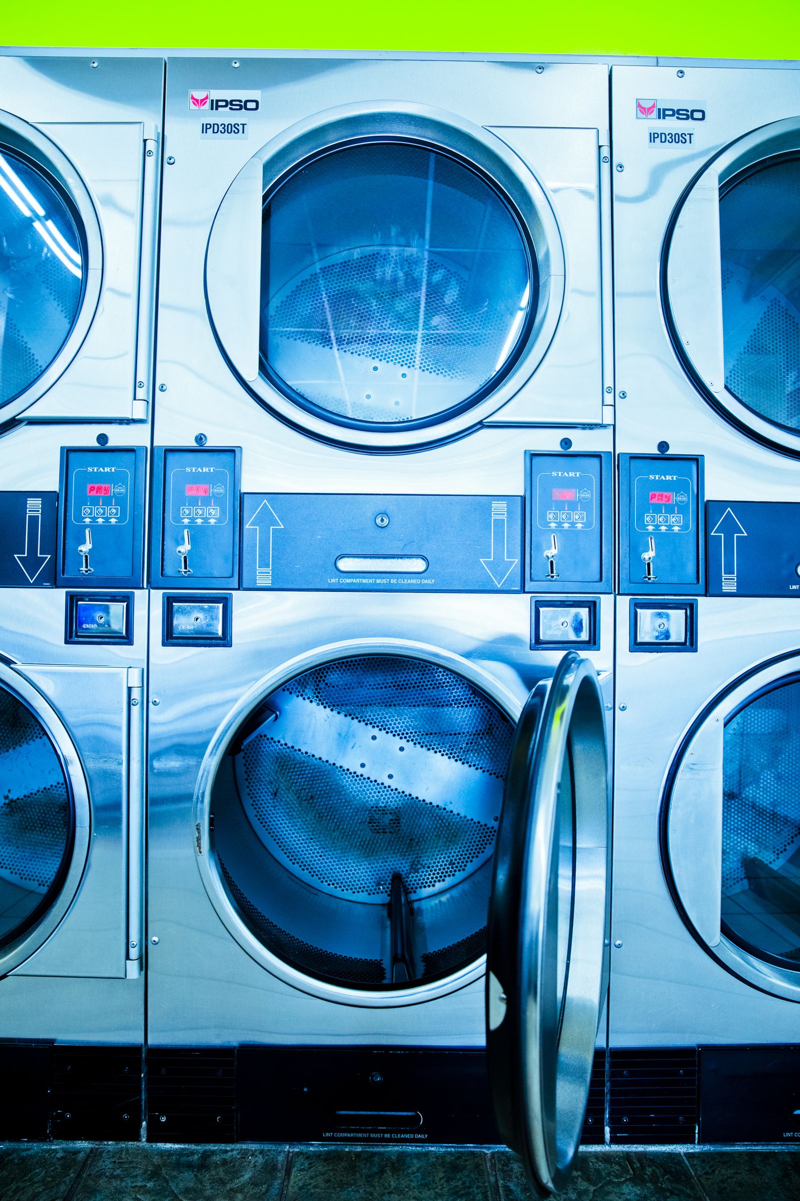 Stacked IPSO dryers, one lower door open showing drum
