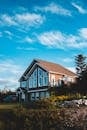 Modern cottage in summer garden in clear weather