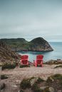 Picturesque landscape of calm abandoned embankment with free chairs on gray nasty day