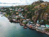 Drone view of picturesque pier with bright buildings rounded with blue endless sea