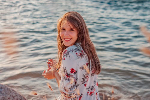 Shallow Focus Photo of Woman in Floral Shirt Smiling