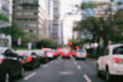 A vibrant city scene with blurred traffic and urban buildings, creating a dynamic atmosphere.