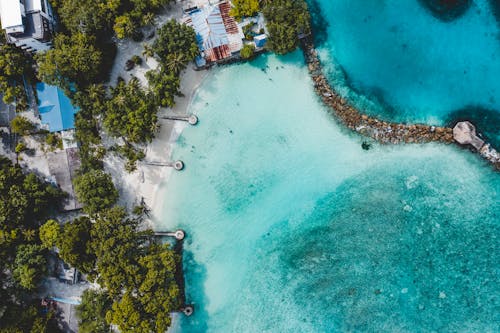 Drone view of azure seawater washing tropical island coast