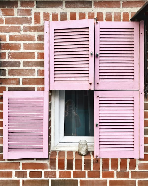 Close-up of a Window with Pink Shutters
