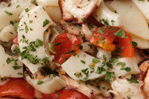 Appetizing homemade dish with squids and tomatoes