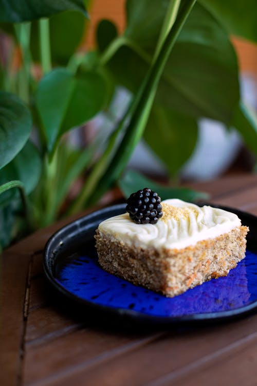 Close-Up Shot of a Slice of Cake with a Berry on Top 