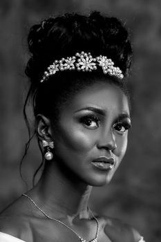 Sophisticated black and white portrait of an elegant woman wearing a tiara.