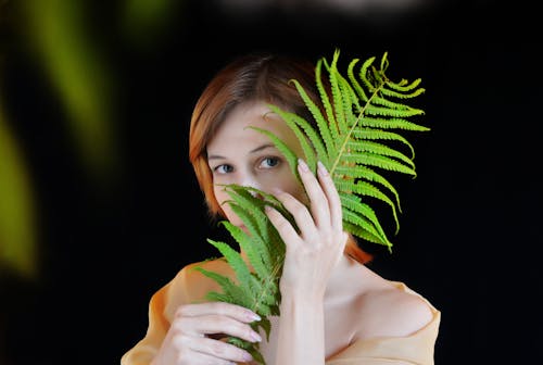 Photo of Woman Holding Fern Plant
