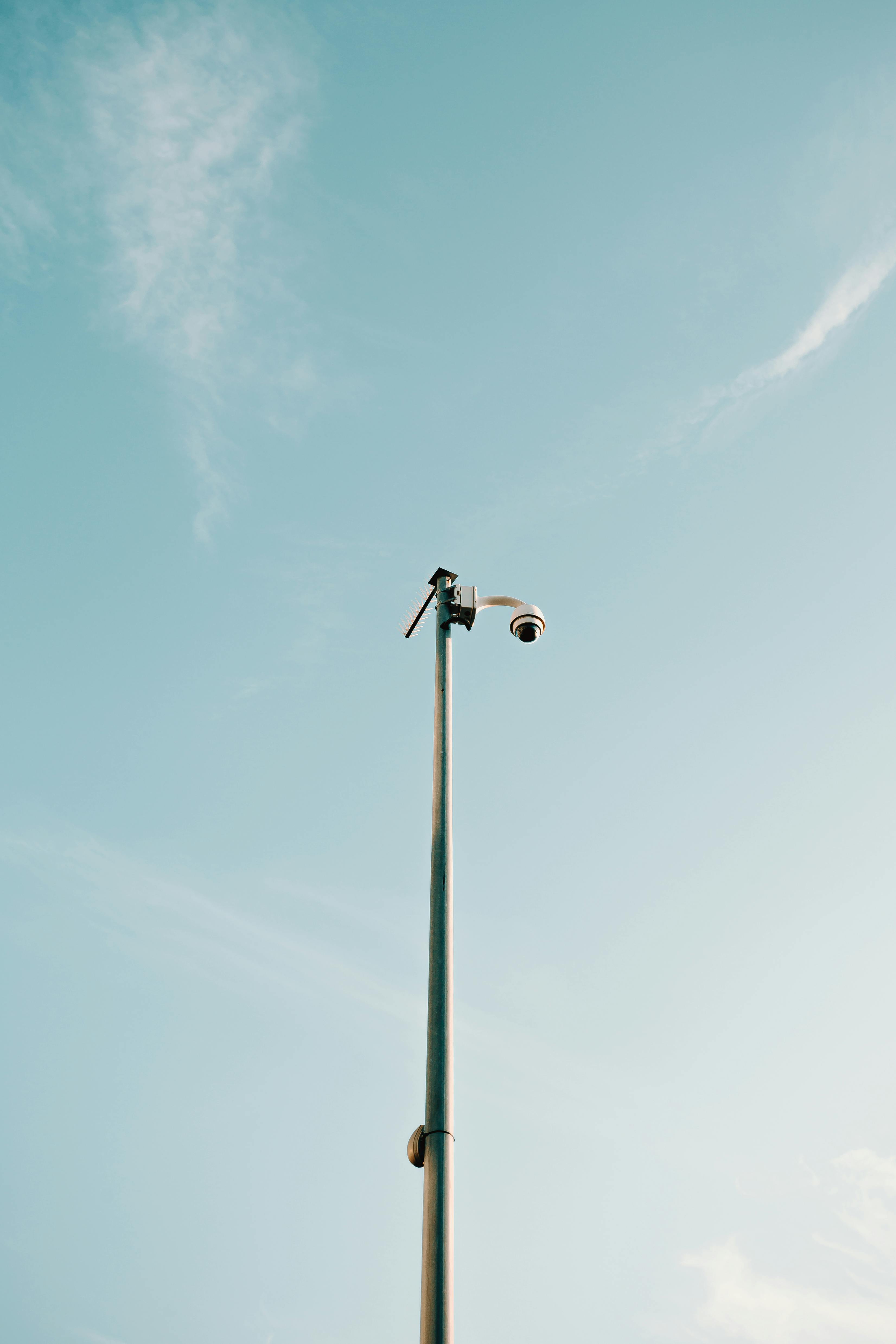 modern security camera on high column