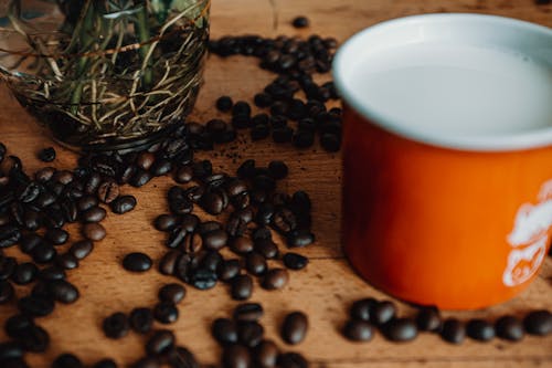 Free Cup of coffee with beans on table Stock Photo