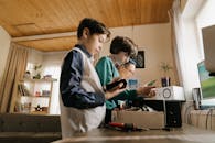 Man in White Dress Shirt Holding Black Smartphone