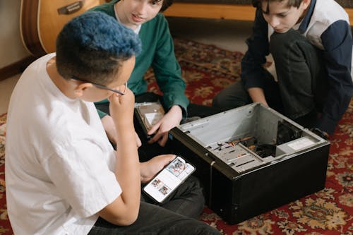 Boy in White Dress Shirt Holding Black Smartphone