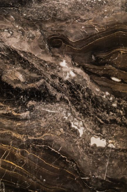 Detailed view of a textured marble surface showing intricate patterns and natural hues.