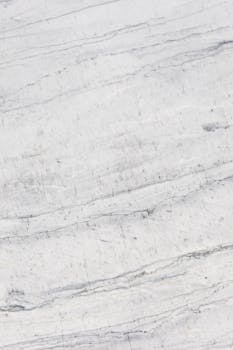 Close-up of natural white marble texture with subtle veining, perfect for backgrounds or design.