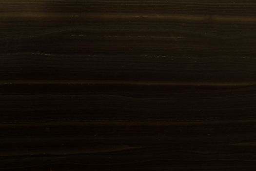 Closeup of a dark wooden surface texture, perfect for backgrounds or patterns.