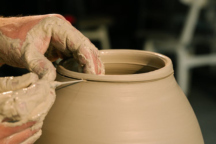 Close-Up Shot Of A Person Molding A Pot