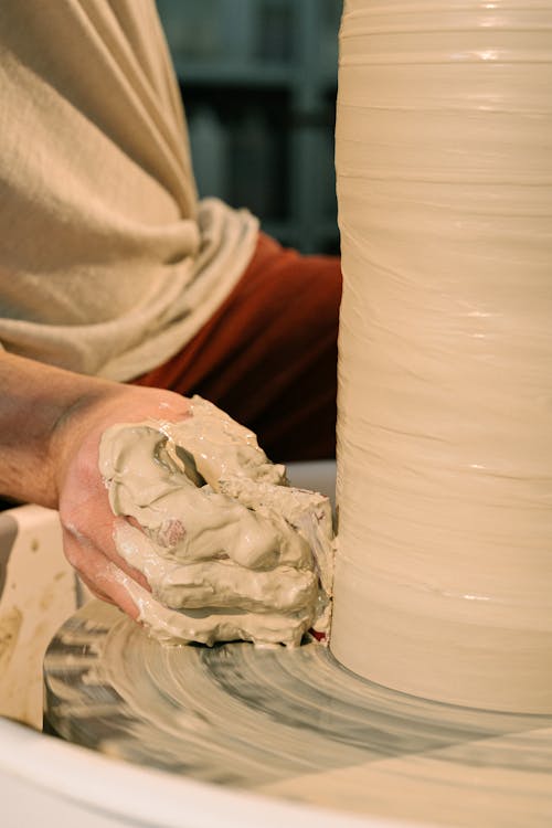 Close-Up Shot of a Person Molding a Pot