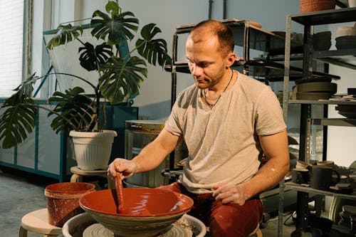 Man in Brown Crew Neck T-shirt Molding Brown Ceramic Bowl
