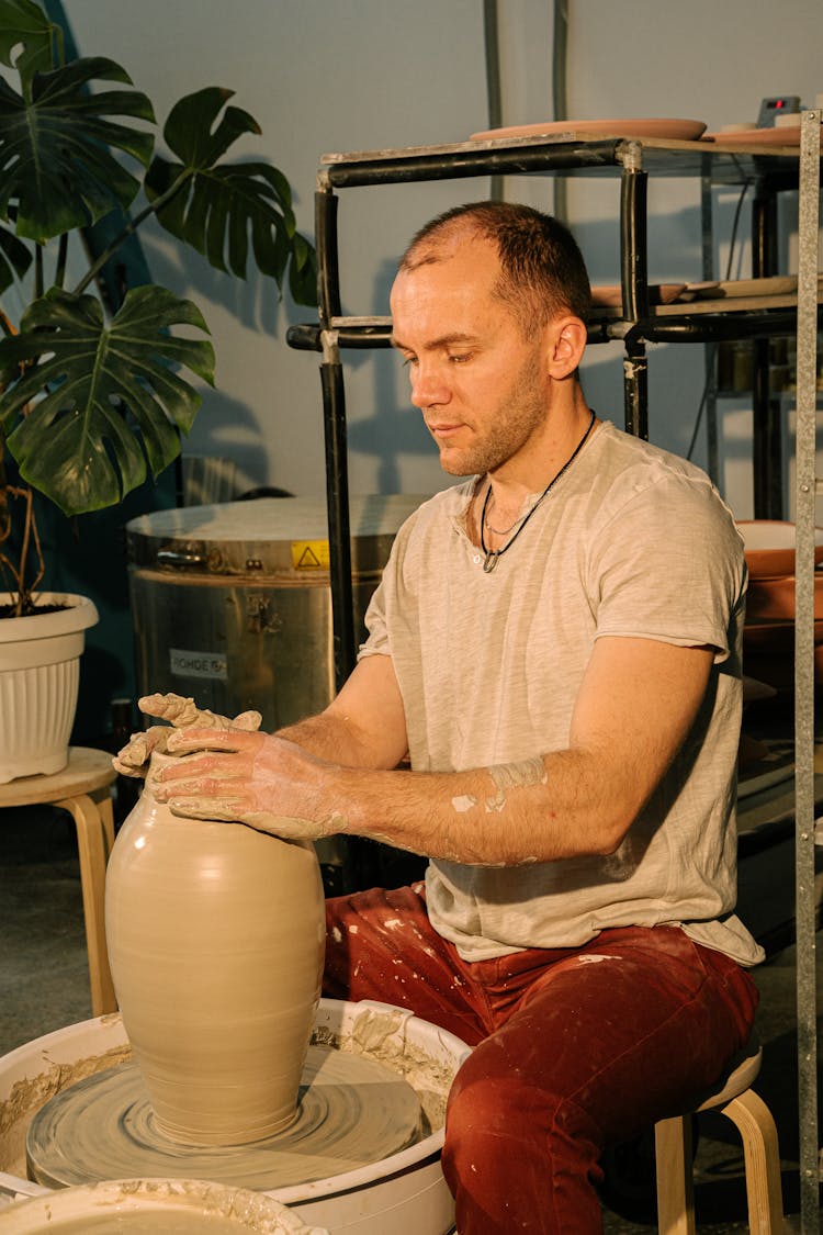 Photo Of Man Molding Clay Jar