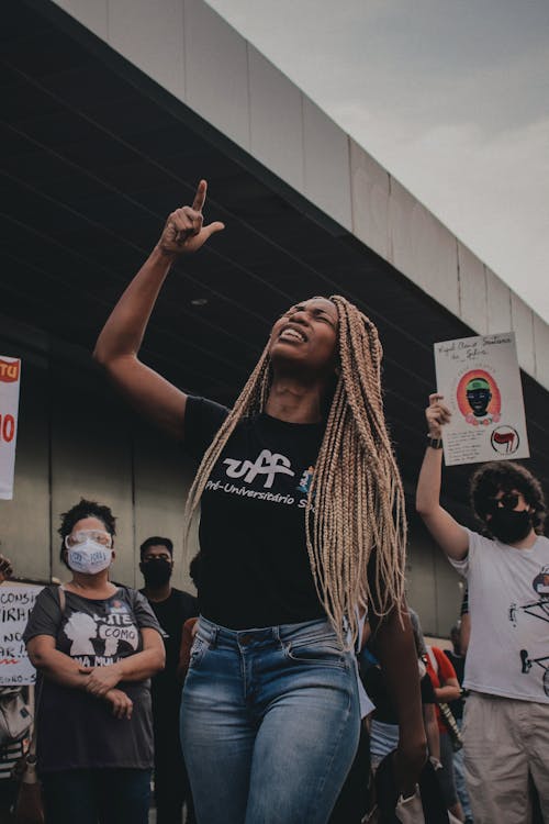 Photo of Woman Raising Her Right Hand