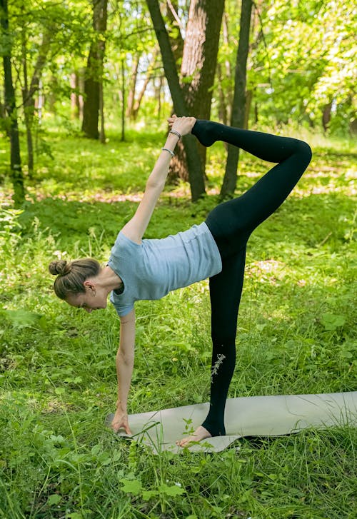 Flexible Woman in Blue Shirt Working Out