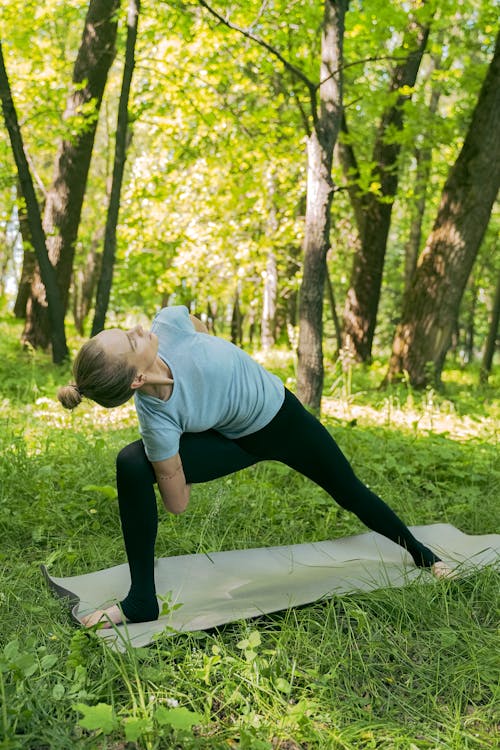 Free Woman in Light Blue Shirt Doing Stretching Stock Photo