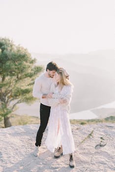 Couple embracing outdoors, exuding romance and love in a natural setting.