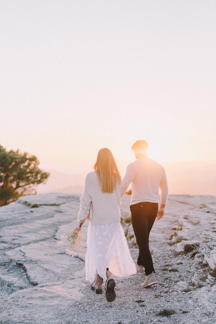 A Couple Walking On Mountain