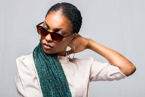 A Woman in White Long Sleeve Shirt Wearing Brown Sunglasses