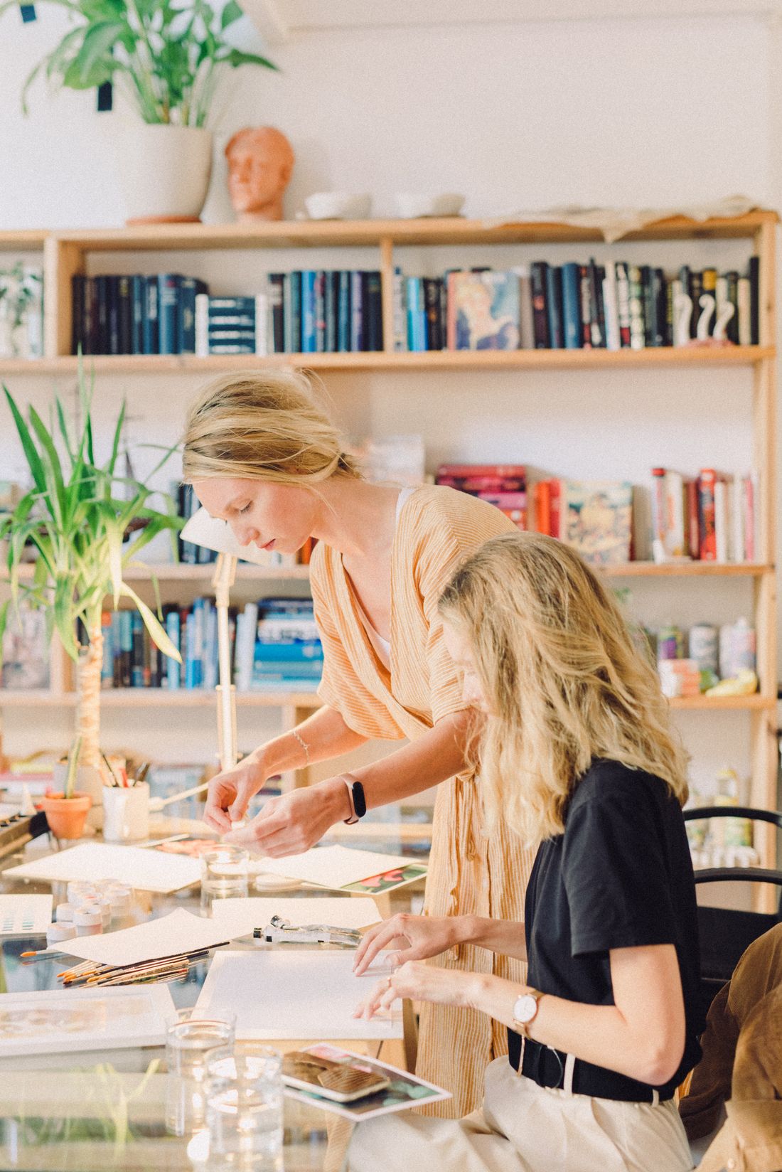 An educator seated at a table, calm and attentive