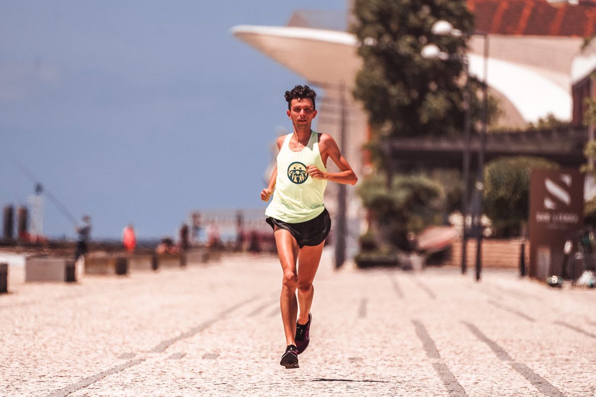 Sportsman jogging outdoors in performance training clothing