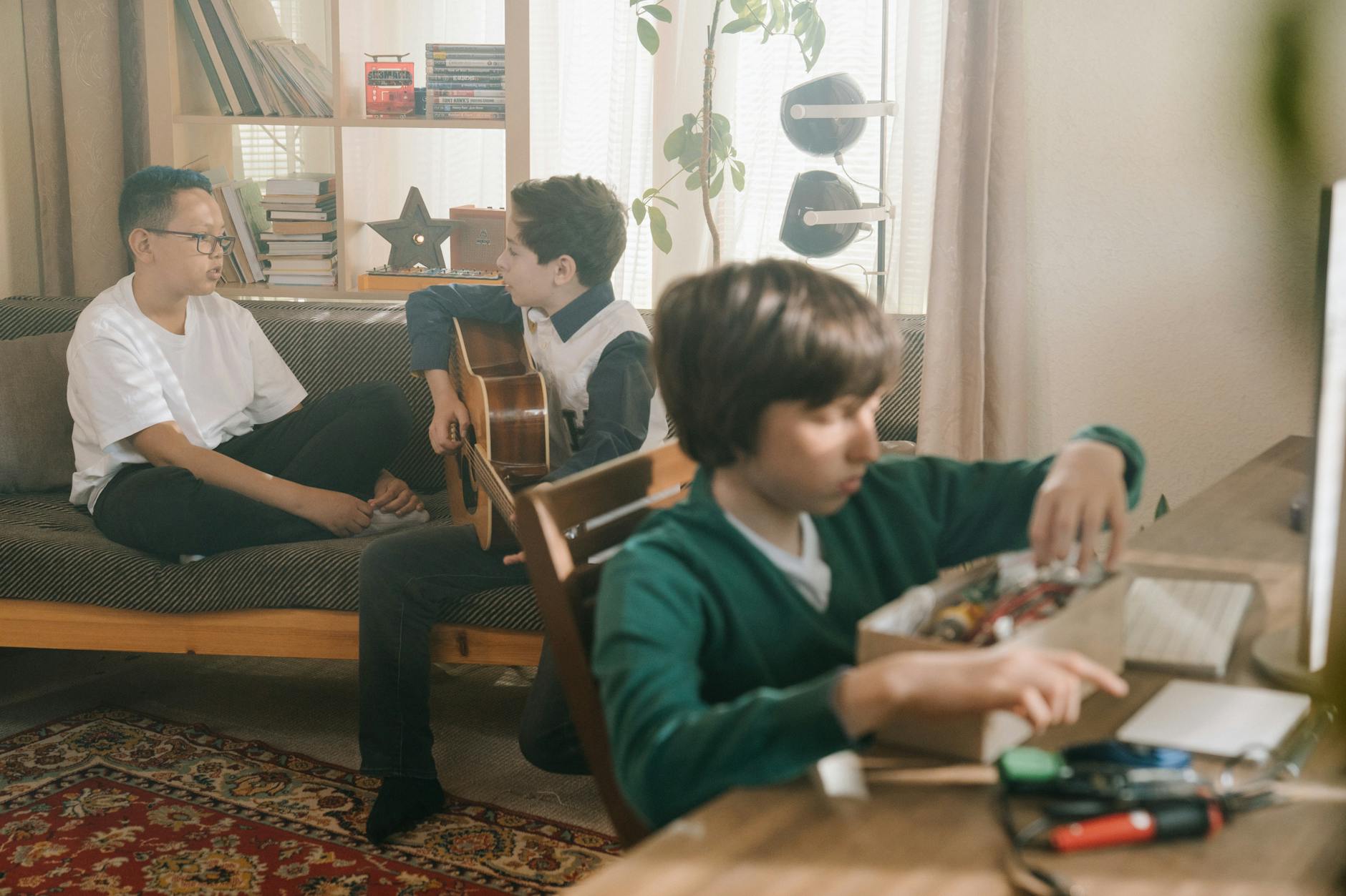 Boy in Green Jacket Sitting on Chair