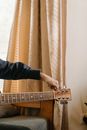 Person Playing Guitar Near Brown Curtain