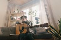 Man in Black Shirt Playing Acoustic Guitar