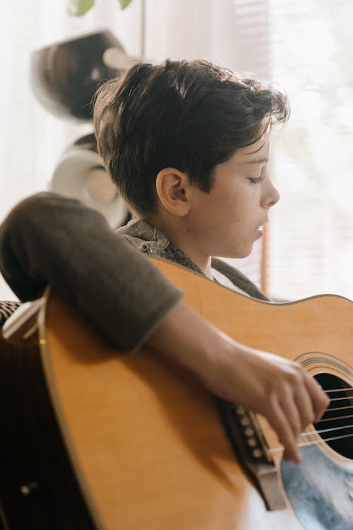 Free Boy in Black T-shirt Playing Brown Acoustic Guitar Stock Photo