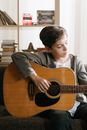 Boy in Gray Sweater Playing Brown Acoustic Guitar