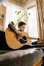 Man in Black Shirt Playing Acoustic Guitar