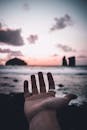 A Man Extending his Hand Towards the Sea