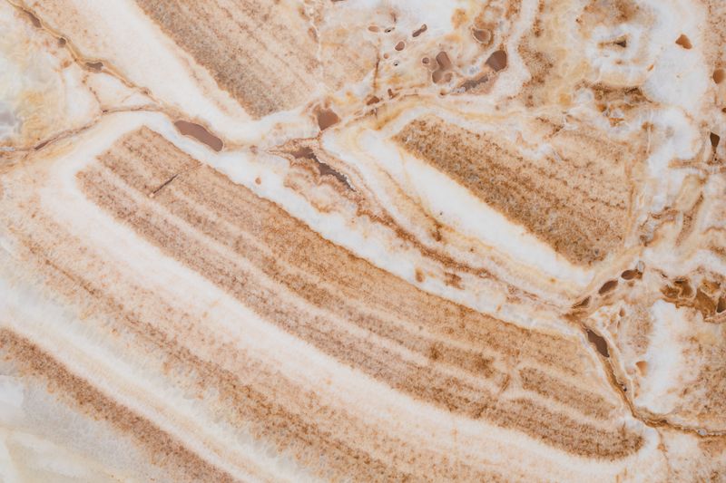 Limestone surface — warm brown and white sedimentary texture with natural character