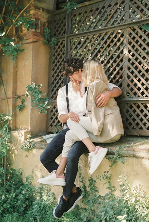 Kissing Couple Sitting on the Fence