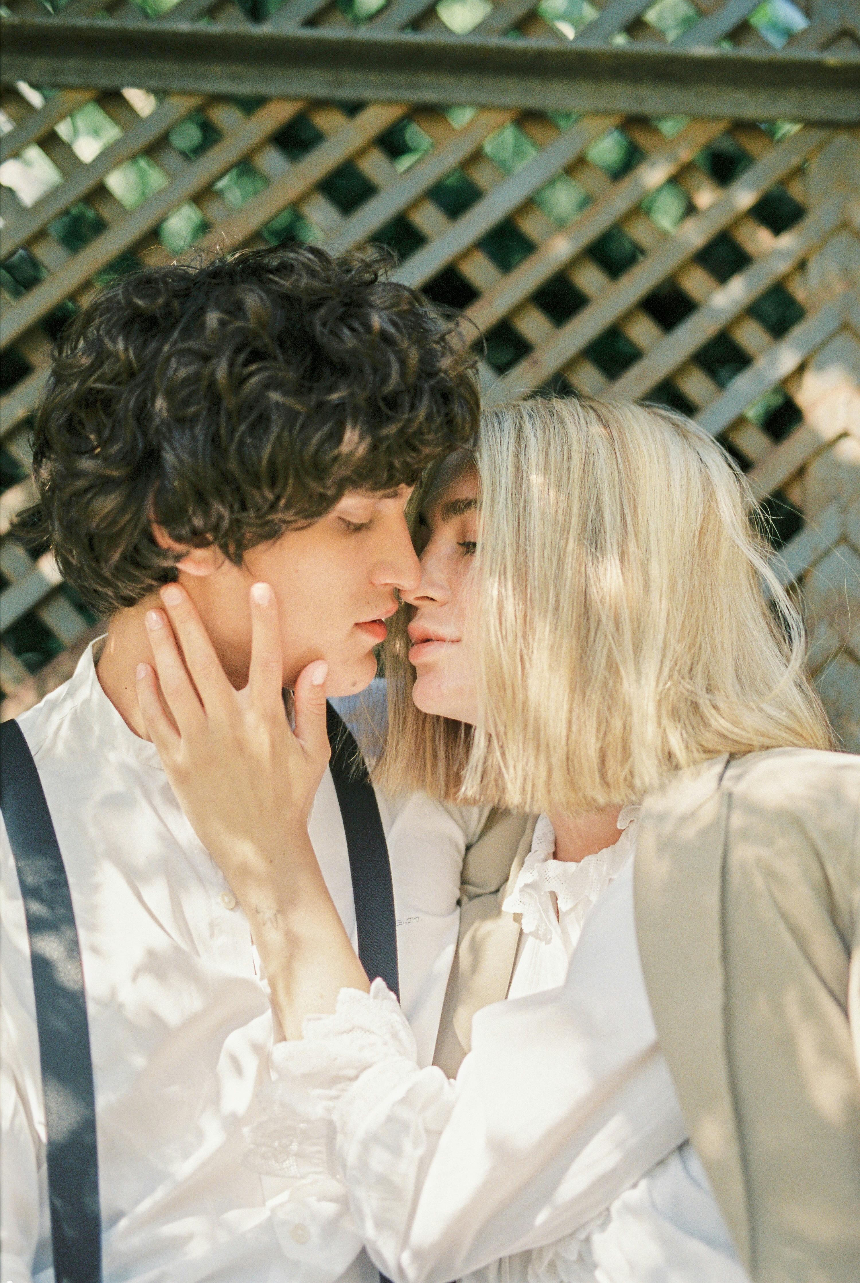 blond woman and a man kissing