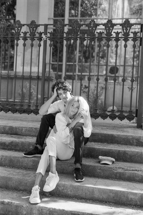 Black and White Photo of a Couple on the Stairs