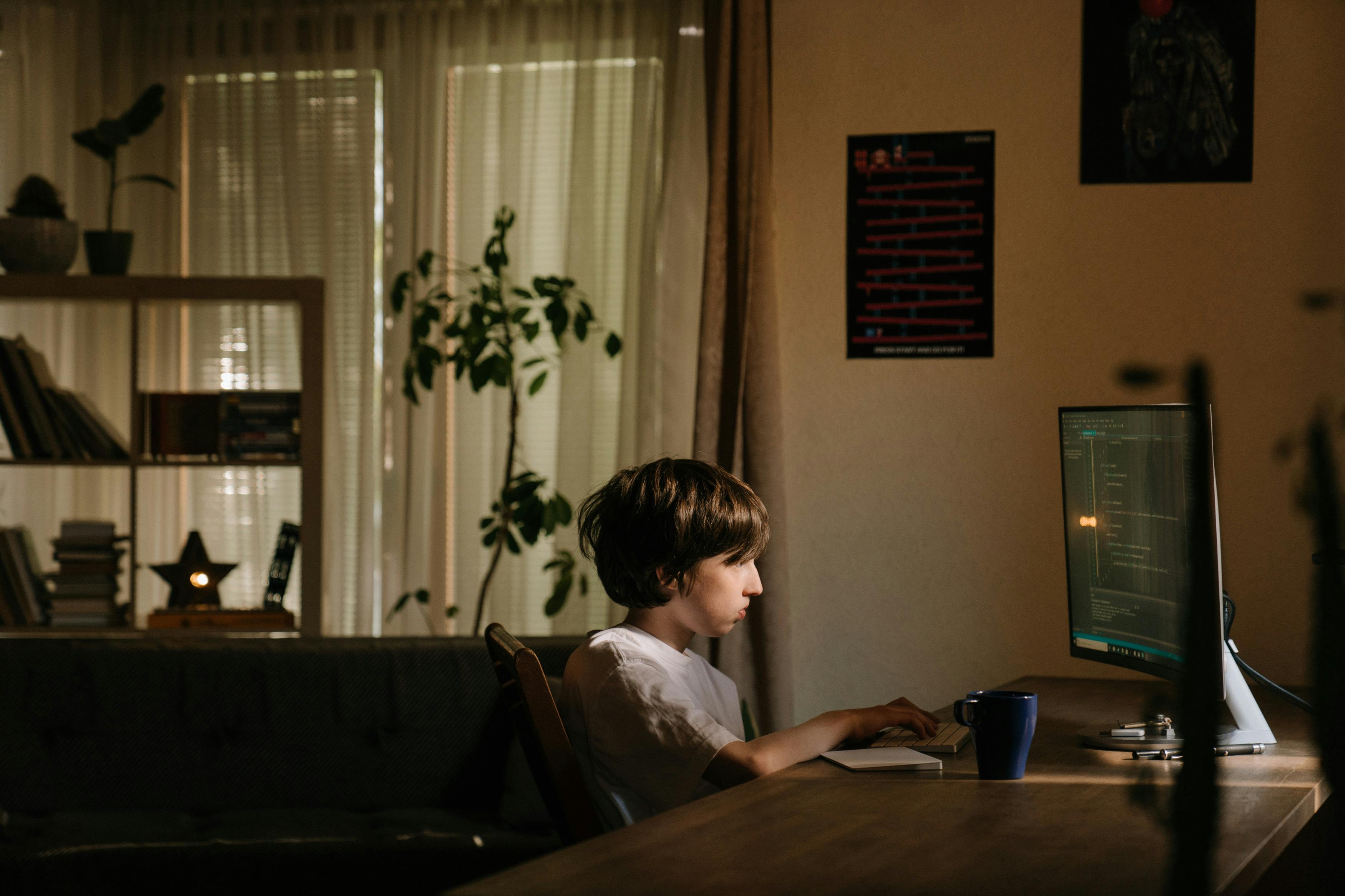 boy in white shirt sitting on chair