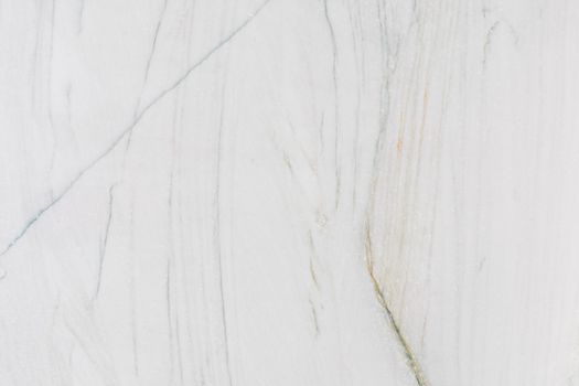 High-resolution image of a smooth white marble surface with gentle veining, ideal for design and decor.