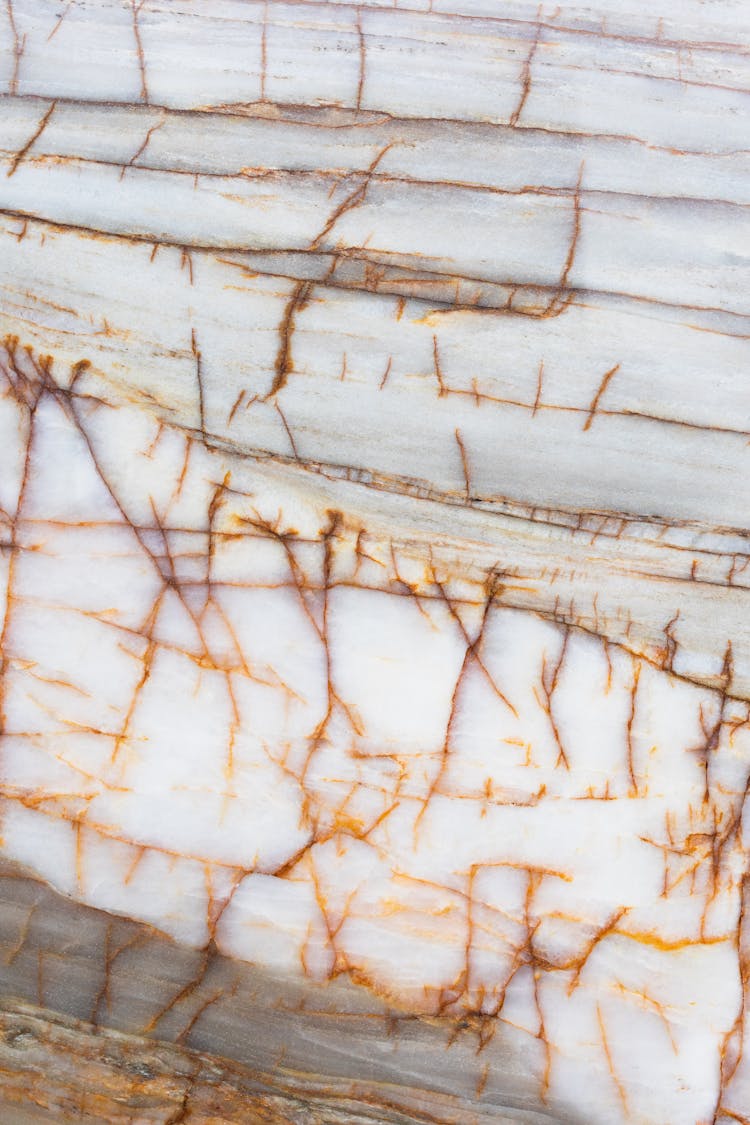 White Marble Surface With Yellow Cracks