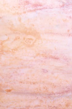 Close-up texture of soft pink marble, perfect for design backgrounds and projects.