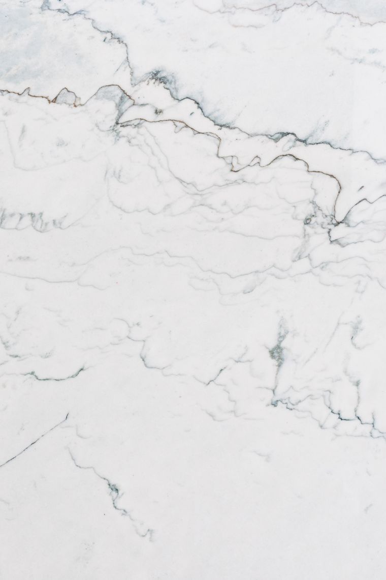 Polished white marble slab showing natural grey veining at a UAE stone warehouse