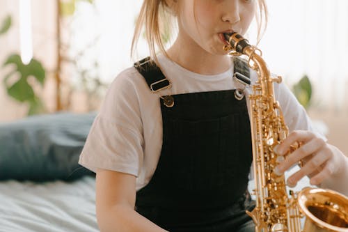 Woman in White Shirt Playing Saxophone