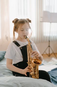 A young girl playing the saxophone in a bright, indoor setting. Perfect for depicting musical passion and childhood hobbies.