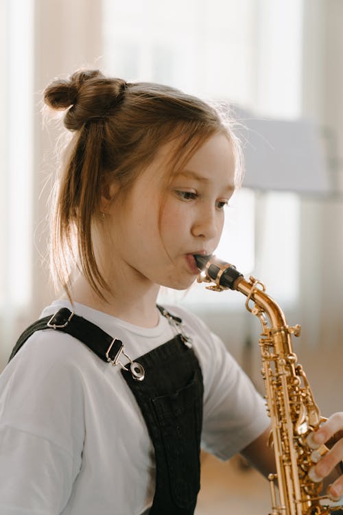 Woman in Black and White Shirt Playing Saxophone